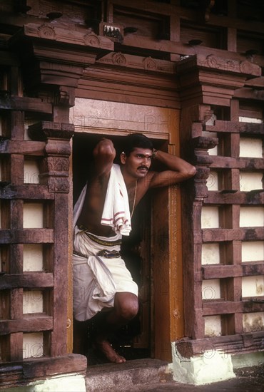 Priest standing at Thirunakkara Siva Temple in Kottayam