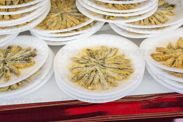 Set of plates with fried anchovies fish as seafood