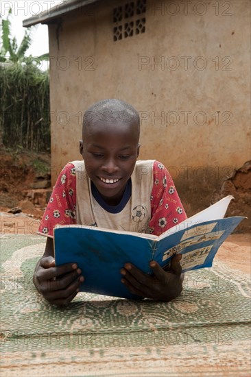 Children reading from a textbook at home