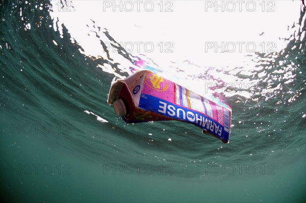 Milk carton floating in sea