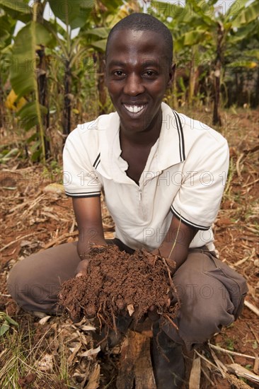 Farmer with fertile soil mixed with compost