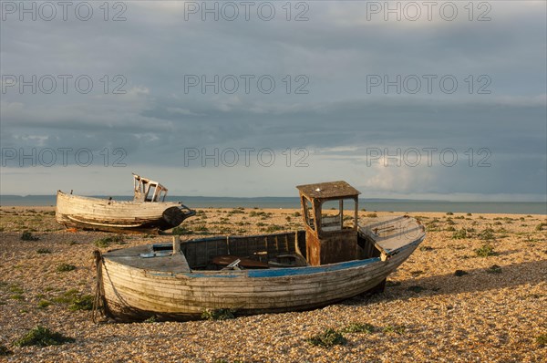 Abandoned fishing boats on a shingle beach