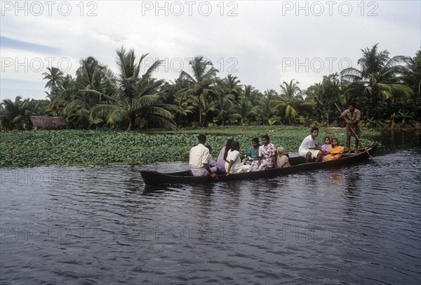 A boat man taking people to their village in a small boat