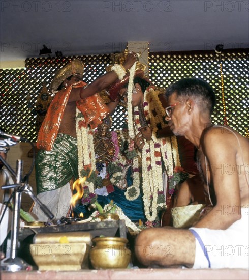 Priests exchanging garlands