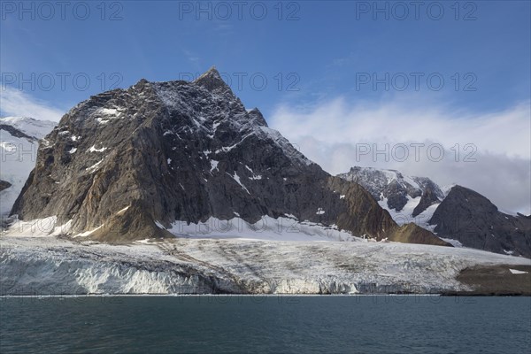 View of fjord coastline with glacier and mountains