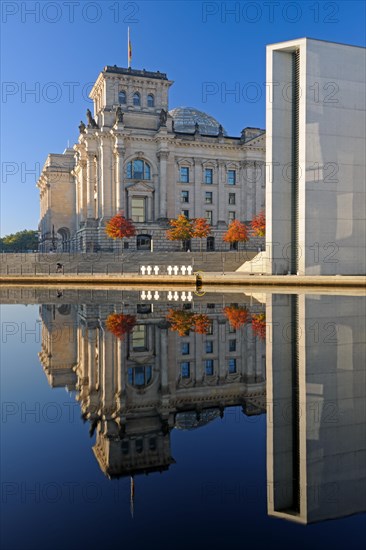 Reichstag and Paul-Loebe-Haus reflected in the Spree at sunrise