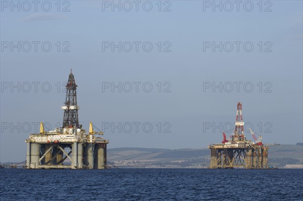 Oil rigs moored in sea near coast