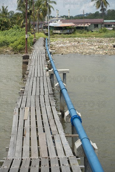 Wooden footbridge with blue hookah over the river