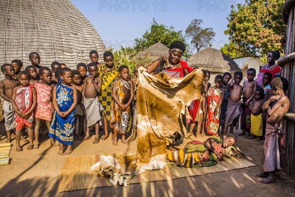 Children watch with interest at traditional customs in real African village