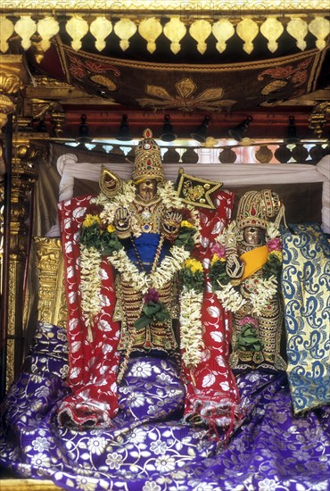 Decorated urchava deity Lord Subramanya and Goddess Deivanai or Devasena in Tirupparankundram or Thiruparankundram temple near Madurai