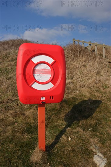 Lifebuoy in container on beach