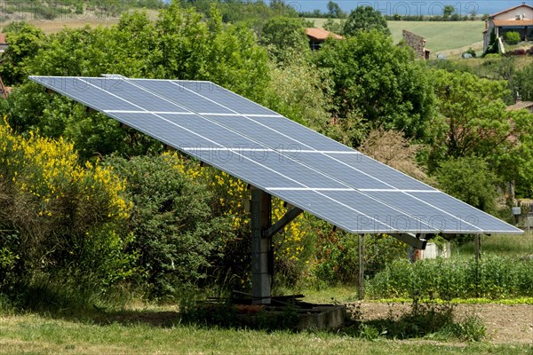 Solar panels in a garden. Auvergne Rhone Alpes. France