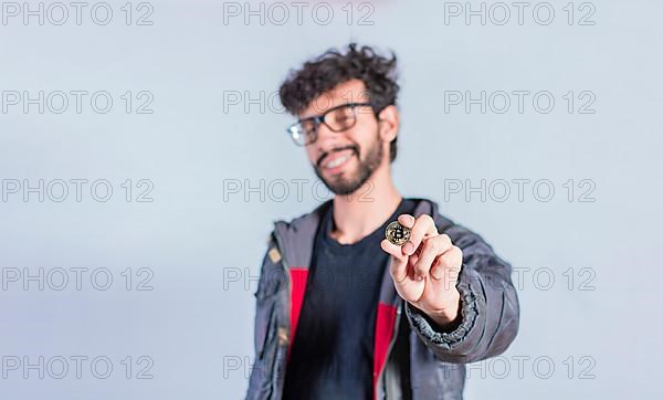 Smiling man holding bitcoin coin