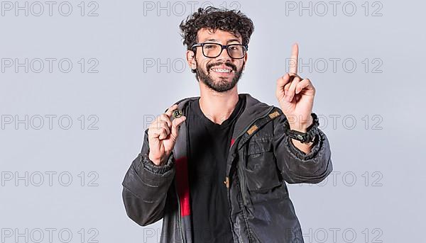 Smiling man holding bitcoin coin and lifting finger
