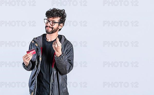 Handsome man with credit card making money gesture with fingers