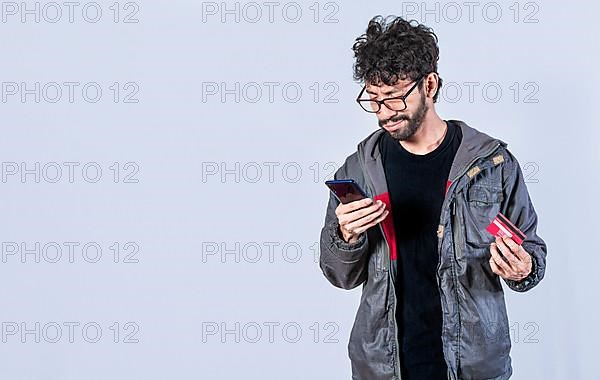 Handsome man paying from his phone with a credit card