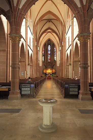 Interior view with baptismal font of the Herz Jesu church in historicism in Stuehlinger