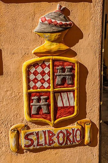Coat of arms and lettering of San Liborio on house wall