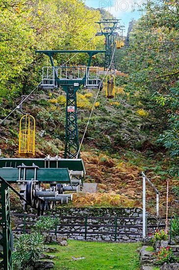 Cable car and cable car masts of Cabinovia Monte Capanne with open gondola cable car gondola standing gondola on mountain Monte Capanne