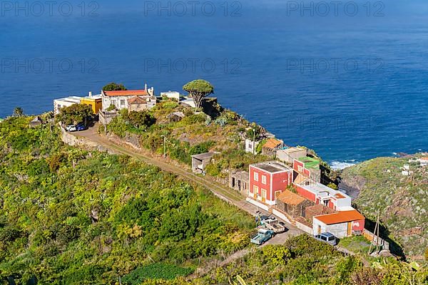 Houses in the village of El Tablado and cliffs on the Atlantic Ocean