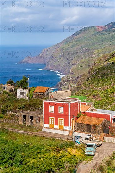 Houses in the village of El Tablado and cliffs on the Atlantic Ocean