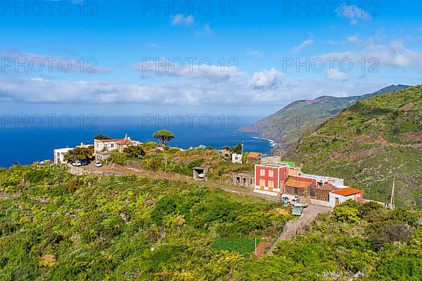 Houses in the village of El Tablado and cliffs on the Atlantic Ocean