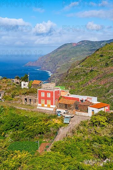 Houses in the village of El Tablado and cliffs on the Atlantic Ocean