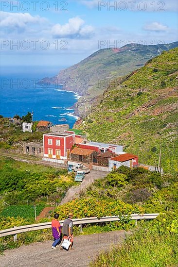 Houses in the village of El Tablado and cliffs on the Atlantic Ocean