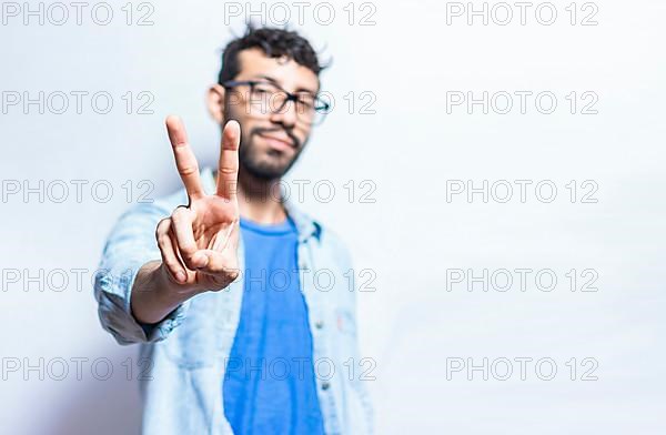 People finger counting the number two on an isolated background. Person hand counting number two. Handsome guy hand showing number two