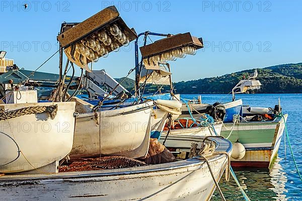 Local fishing boats with lamps with traditional light bulb bulbs for night fishing at night in harbour of Mediterranean Sea