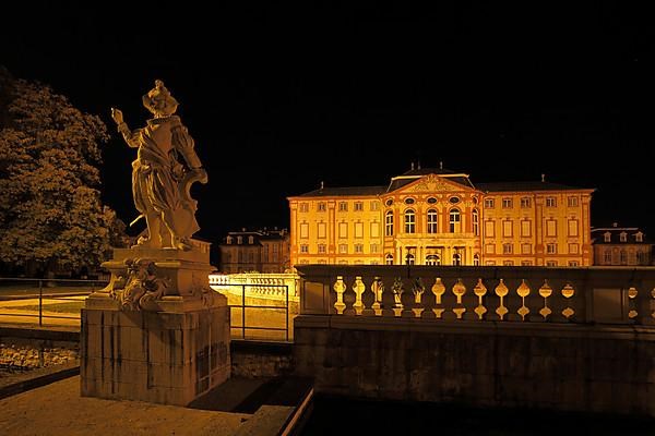 Castle garden with statue of the nobleman at night at the baroque castle