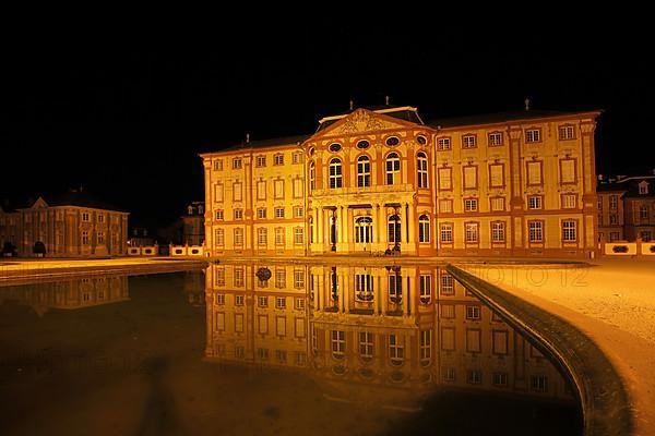 Reflection in the water basin at night of the baroque castle