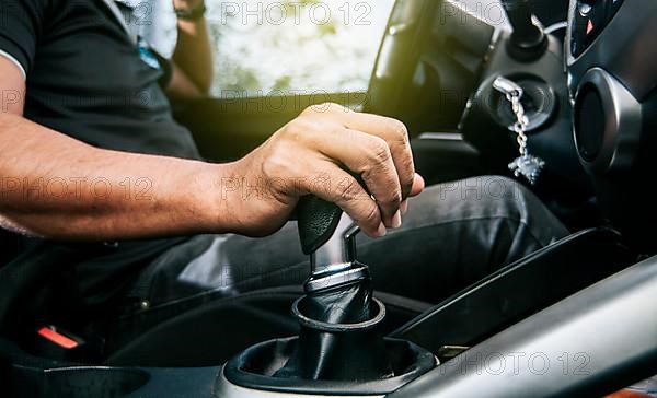 Concept of hand grabbing the gear lever of a car with copy space