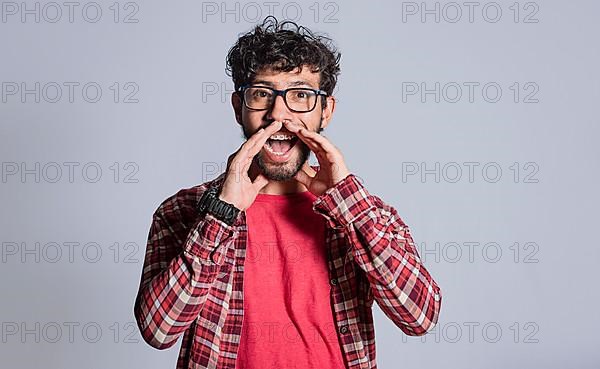 Person announcing and shouting with hands. Attractive man announcing and shouting with hands