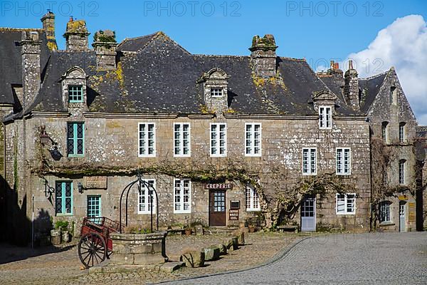 Village square with old horse-drawn cart and fountain