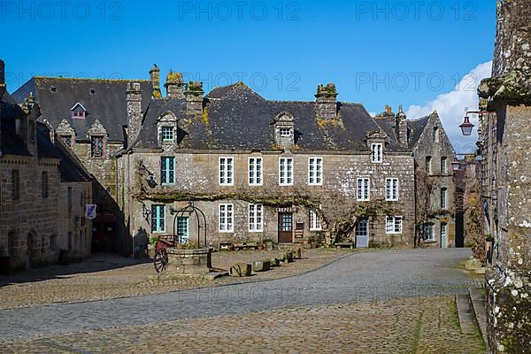 Village square with old horse-drawn cart and fountain