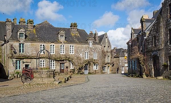 Village square with old horse-drawn cart and fountain