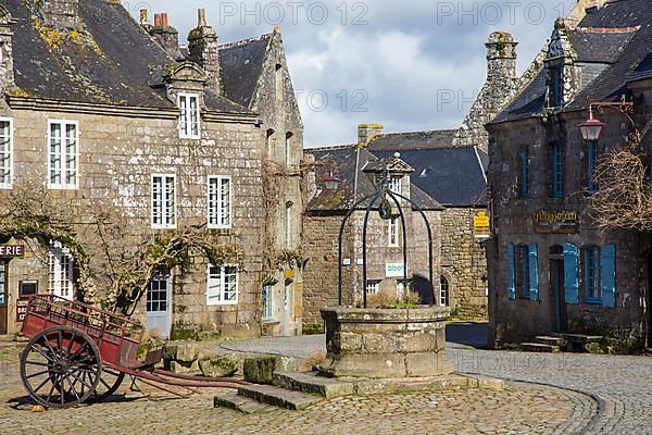 Village square with old horse-drawn cart and fountain