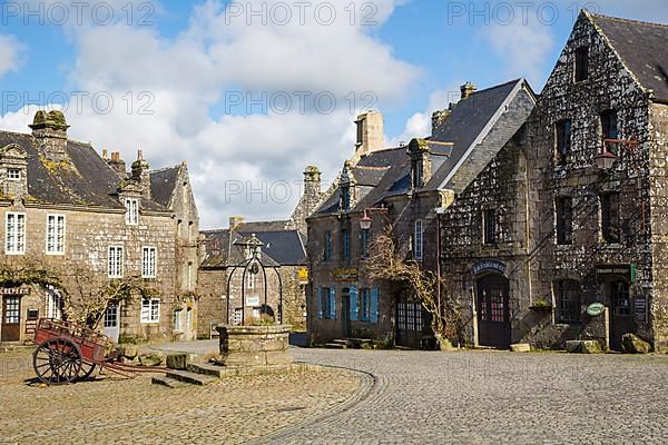 Village square with old horse-drawn cart and fountain