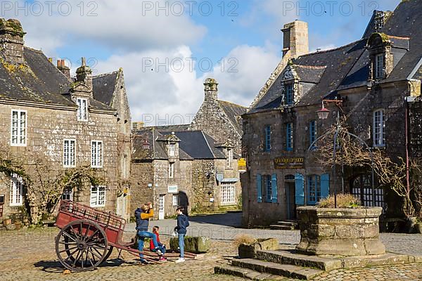 Village square with old horse-drawn cart and fountain