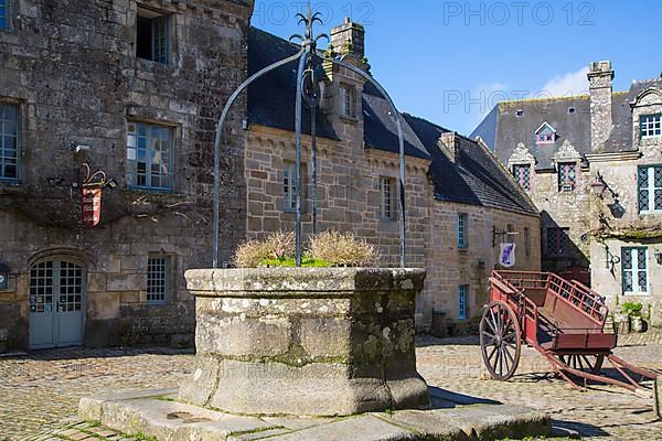 Village square with old horse-drawn cart and fountain