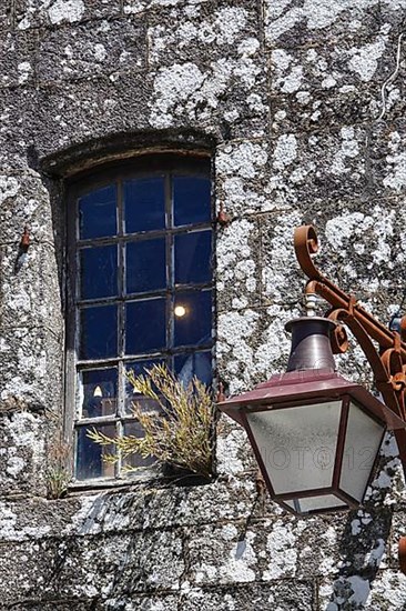 Window and street lamp on an old stone house
