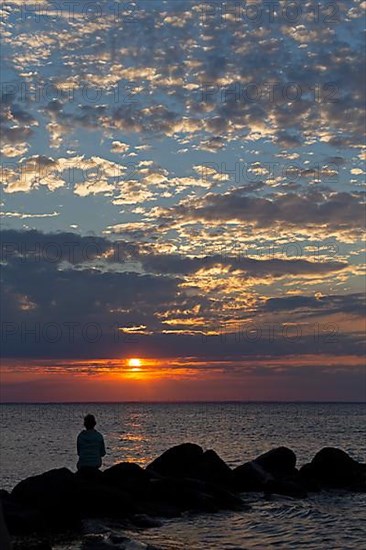 Woman sitting on stones