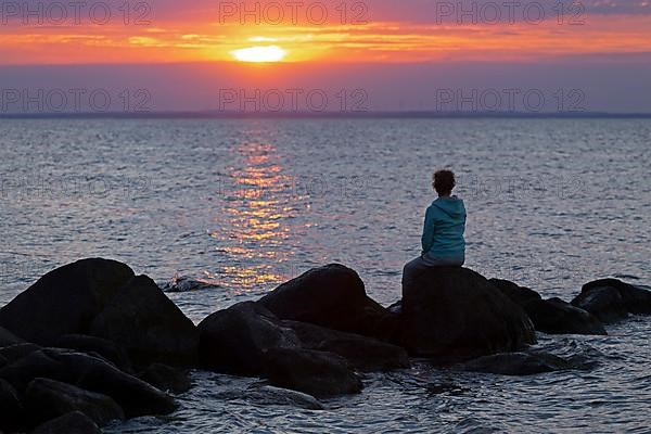 Woman sitting on stones