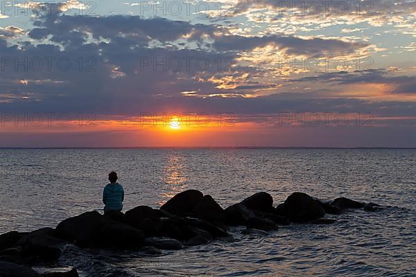 Woman sitting on stones