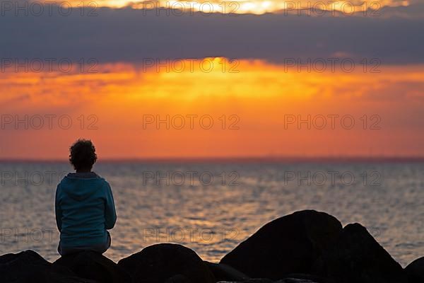 Woman sitting on stones