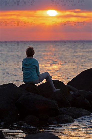 Woman sitting on stones