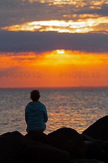 Woman sitting on stones