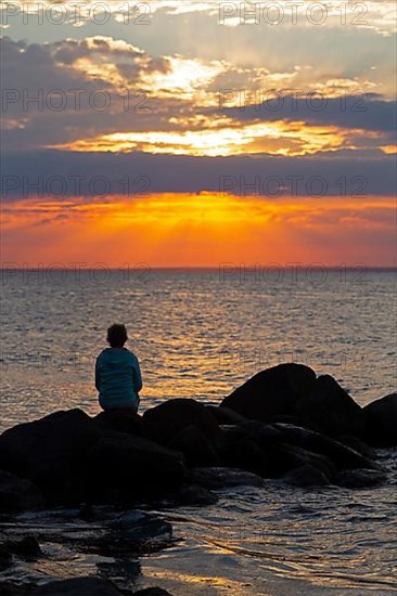 Woman sitting on stones