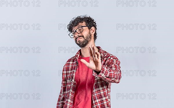 Person with hand in front rejecting something. Negative man rejecting with one hand